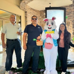 people posing with an Easter Bunny