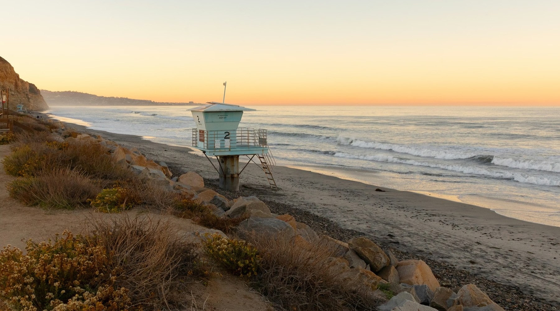 a beach with a lifeguard tower